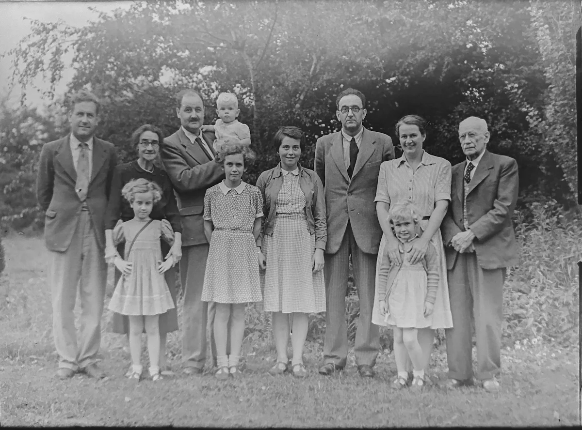 A black-and-white group photograph of three generations of a family